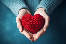 Elderly Female Hands Holding A Knitted Red Heart Made Of Threads.ai Generative