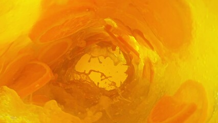 Wall Mural - Super slow motion of mixing orange juice in twister shape. Filmed on high speed cinema camera, 1000 fps.