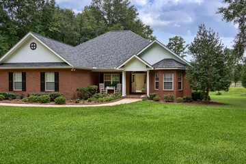 Traditional Brick House on Green Lawn with Mature Trees