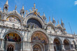 Details of St Mark's Basilica or the Basilica di San Marco in Italian, golden mosaics, intricate carvings, and statues adorn the roof of St. Mark's Basilica, a true marvel of Byzantine art in Venice.