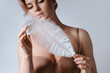 © blackday - Portrait of young and sensual woman with soft ostrich feather
