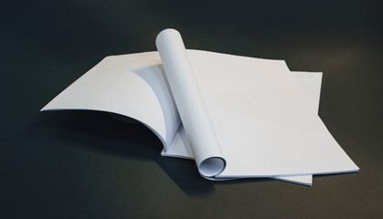 Paper magazine mockup. Open blank pages. Dark background.