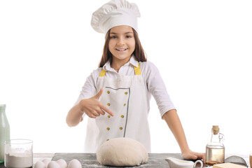 Canvas Print - Little baker pointing at dough on table against white background