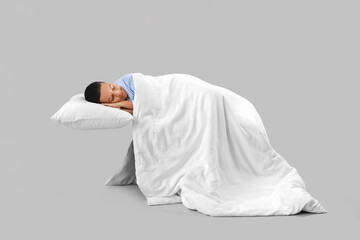 Poster - Little African-American boy with soft blanket sleeping on light background