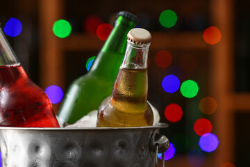 Bucket with bottles of cold beer in bar, closeup