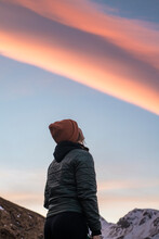 View Of A Girl Below A Pink And Blue Sundown In The Amazing Landscape Of XXX, Iceland.