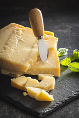 Wall Mural - Tasty parmesan cheese on cutting board.