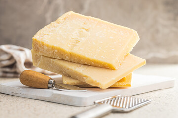 Wall Mural - Tasty parmesan cheese on kitchen table.