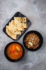 Sticker - Naan flatbread with cilantro, Tom yum soup and rice noodle pad thai with squid.