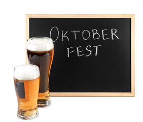 Glasses of cold beer and chalkboard with word OKTOBERFEST on white background