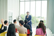 © FotoArtist - conference meeting. Business people sitting in a room listening to the motivator coach. Representation of a Self-growth and improvement special event
