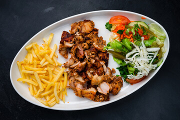 Sticker - Chicken meat with french fries and a salad of pickled cucumbers, tomatoes, carrots, lettuce and parsley, shawarma.