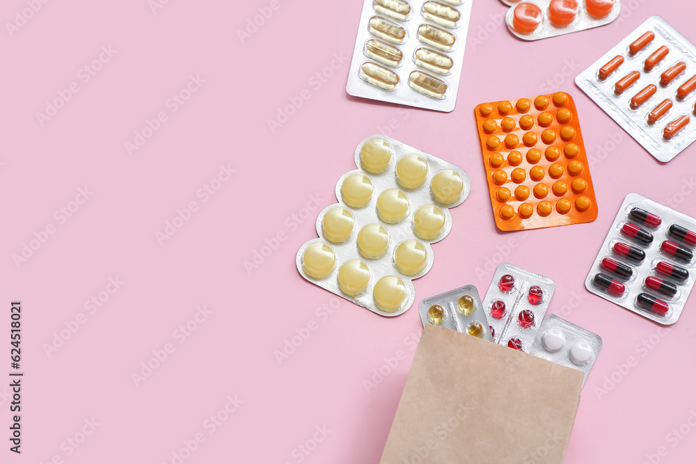 Shopping bag with different pills in blister packs on pink background
