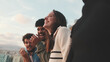 © Andrii Nekrasov - Close-up of young people, guys and girls friends standing hugging each other on the balcony looking at the beautiful views