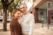 © Prostock-studio - Smiling Senior Couple In Casual Outfit Standing On Street Outdoors