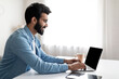 © Prostock-studio - Smiling Indian Man Working On Laptop With Blank Black Screen At Home