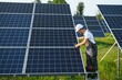 © Serhii - Worker installing solar panels outdoors.