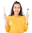 Young beauty Asian woman showing Knife Fork prepare to eat food and she wearing a yellow sweater shot isolated on white background