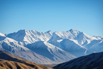 Canvas Print - majestic mountain range, with snow-capped peaks and clear blue skies, created with generative ai