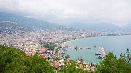 Wall Mural - Aerial view resort city Alanya with harbor and beach in southern coast of Turkey in cloudy day