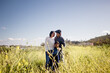 © Cavan Images - Asian Family of Three Standing in Wildflower Field in San Diego