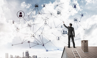 Wall Mural - businessman on house roof presenting networking and connection c