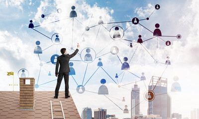 Wall Mural - businessman on house roof presenting networking and connection concept. mixed media