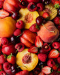 © Cavan Images - Close up of mixed summer fruit: berries, peaches, cherries.