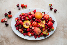 Top View Of Large Plate Of Mixed Fruit: Berries, Peaches, Cherries.
