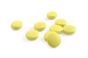 Many yellow pills isolated on white. Medicinal treatment