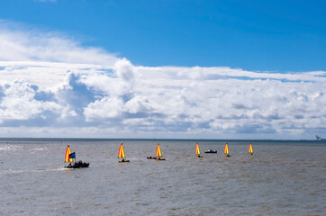 Wall Mural - Scenic sea view with sail boats and kayaks and blue sky with clouds. Ocean water with tpuristic ships in summer sunny day