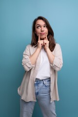 Wall Mural - pretty young brunette female adult in casual shirt on studio background