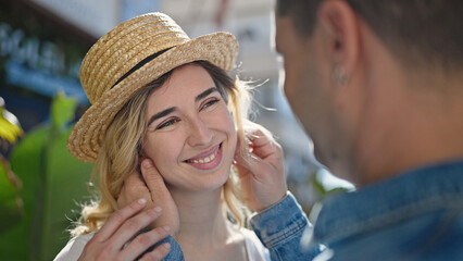 Poster - Man and woman couple smiling confident wearing summer hat at park