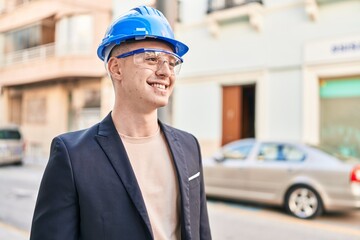 Wall Mural - Young hispanic man architect smiling confident standing at street