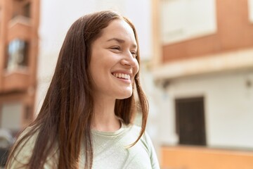 Sticker - Young beautiful woman smiling confident looking to the side at street