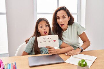 Sticker - Young mother and daughter holding my mom is the best scared and amazed with open mouth for surprise, disbelief face