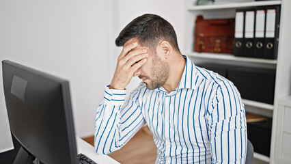 Sticker - Young hispanic man business worker stressed using computer at office