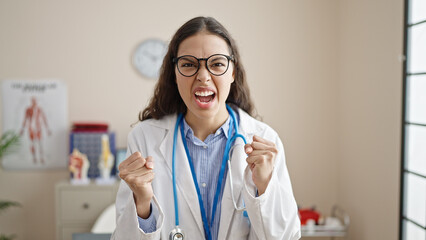 Sticker - Young beautiful hispanic woman doctor angry and stressed at clinic