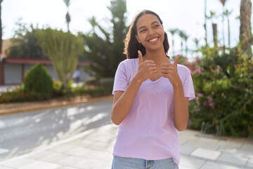 Sticker - Young african american woman smiling confident doing ok sign with thumbs up at street