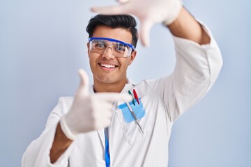 Poster - Hispanic man working as scientist smiling making frame with hands and fingers with happy face. creativity and photography concept.