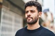 © Krakenimages.com - Young arab man with relaxed expression standing at street