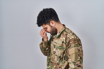 Sticker - Arab man wearing camouflage army uniform tired rubbing nose and eyes feeling fatigue and headache. stress and frustration concept.