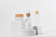 Cosmetics Packaging. Set Of Different Cosmetic Jars And Tubes Of Cream On White Podiums. Blank Packaging. Natural Beauty Spa Product Concept. Beauty.Mock-up