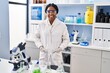 © Krakenimages.com - African american woman scientist smiling confident standing at laboratory