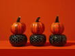 Line of pumpkins over red background.