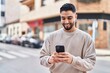 © Krakenimages.com - Young arab man smiling confident using smartphone at street