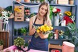 © Krakenimages.com - Young caucasian woman florist holding bouquet of flowers at florist