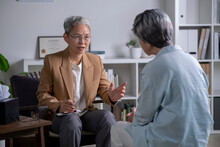 Therapist, Psychologist Talking And Counselling To Asian Patient At Office During Psychology Treatment.
