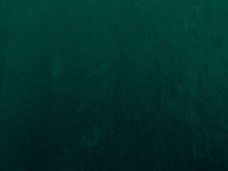 Green velvet fabric texture used as background. Emerald color panne fabric background of soft and smooth textile material. crushed velvet .luxury emerald tone for silk..