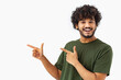© kucherav - Happy Asian man wear green t-shirt smiling and points to an empty space in the frame standing on white background